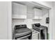 Functional laundry area with washer and dryer hookups and storage at 2528 Barwick Dr, Durham, NC 27704