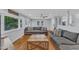 Spacious living room featuring hardwood floors, a large gray sectional sofa, and bright natural light at 2528 Barwick Dr, Durham, NC 27704