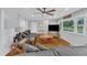 Inviting living room featuring hardwood floors, a large gray sectional, and abundant natural light, creating a cozy atmosphere at 2528 Barwick Dr, Durham, NC 27704