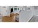 Open-concept living room with hardwood flooring, a comfortable gray sectional and natural light from large windows at 2528 Barwick Dr, Durham, NC 27704