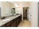 Bathroom vanity featuring granite countertops, double sinks, and access to the walk-in closet at 2609 Kilmartin Dr, Fuquay Varina, NC 27526