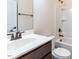 Bathroom with a single sink vanity, mirror, and a shower-tub combination at 2609 Kilmartin Dr, Fuquay Varina, NC 27526