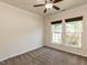 Empty bedroom with carpeted floors, ceiling fan, and two windows providing natural light at 2609 Kilmartin Dr, Fuquay Varina, NC 27526