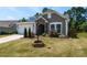 Beautiful single-story home featuring a manicured lawn, a charming stone-accented entrance, and a two-car garage at 2609 Kilmartin Dr, Fuquay Varina, NC 27526