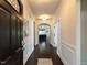 Inviting hallway with dark hardwood floors, elegant wainscoting, and a view into the open living area at 2609 Kilmartin Dr, Fuquay Varina, NC 27526