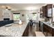 Modern kitchen featuring granite countertops, a breakfast bar, stainless steel appliances, and hardwood floors, plus open-concept dining at 2609 Kilmartin Dr, Fuquay Varina, NC 27526