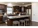 Modern kitchen featuring granite countertops, stainless steel appliances, and an island with barstool seating at 2609 Kilmartin Dr, Fuquay Varina, NC 27526