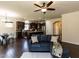 Inviting living room showcasing hardwood floors, a comfortable blue sofa, and a seamless transition to the kitchen at 2609 Kilmartin Dr, Fuquay Varina, NC 27526