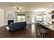 Open-concept living space with a fireplace, hardwood floors, and a breakfast bar connecting to the kitchen at 2609 Kilmartin Dr, Fuquay Varina, NC 27526