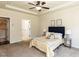 Spacious bedroom with carpeted floors, ceiling fan, and access to a laundry room at 2609 Kilmartin Dr, Fuquay Varina, NC 27526