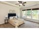 Bedroom with carpeted floors, ceiling fan, and multiple windows providing ample natural light at 2609 Kilmartin Dr, Fuquay Varina, NC 27526