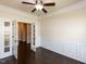 Bright office featuring beautiful wainscoting, dark hardwood floors and glass paneled french doors at 2609 Kilmartin Dr, Fuquay Varina, NC 27526