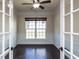 Office with hardwood floors, wainscoting, and a large window with a view of the front yard at 2609 Kilmartin Dr, Fuquay Varina, NC 27526