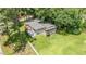 An aerial view of a charming house, showcasing its lush green lawn and a mature tree setting at 3012 Optimist Farm Rd, Apex, NC 27539