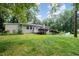 A spacious backyard featuring lush green grass and mature trees creates a private outdoor oasis at 3012 Optimist Farm Rd, Apex, NC 27539