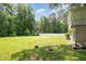 Expansive backyard enclosed by a white fence, providing privacy and room to roam at 3012 Optimist Farm Rd, Apex, NC 27539