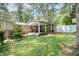 Backyard with a large garage and a sprawling lawn at 3012 Optimist Farm Rd, Apex, NC 27539