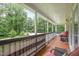 Outdoor balcony with seating and beautiful green views, perfect for relaxation at 3012 Optimist Farm Rd, Apex, NC 27539