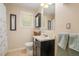Bright bathroom features a vanity with sleek black cabinet, white countertops and a framed mirror at 3012 Optimist Farm Rd, Apex, NC 27539