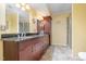 Bathroom featuring dual sinks, granite countertop, walk-in shower, and a stylish vanity at 3012 Optimist Farm Rd, Apex, NC 27539