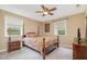 Cozy bedroom featuring carpet, ceiling fan, two windows for natural light and a warm ambiance at 3012 Optimist Farm Rd, Apex, NC 27539