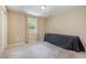 Bedroom features a window with curtains and beige walls with carpeted floors at 3012 Optimist Farm Rd, Apex, NC 27539
