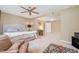 Cozy bedroom boasts a ceiling fan, neutral tones, and lots of space at 3012 Optimist Farm Rd, Apex, NC 27539