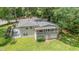 Aerial view of the home featuring a deck, patio, lush lawn, and a neutral beige exterior at 3012 Optimist Farm Rd, Apex, NC 27539