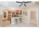 Eat-in kitchen features wooden cabinetry, stainless steel appliances, granite countertops and bar seating at 3012 Optimist Farm Rd, Apex, NC 27539
