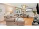 A comfortable living room with neutral tones features a plush sectional and a ceiling fan at 3012 Optimist Farm Rd, Apex, NC 27539