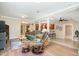 Open-concept living room and kitchen with a sofa, recliner, ceiling fan and wood flooring at 3012 Optimist Farm Rd, Apex, NC 27539