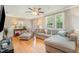 A well-lit living room boasts a modern sofa, a plush chair, and natural light at 3012 Optimist Farm Rd, Apex, NC 27539