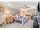 Comfortable main bedroom features a ceiling fan, carpet floors, and natural light from the windows at 3012 Optimist Farm Rd, Apex, NC 27539