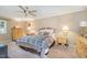 Inviting main bedroom features a ceiling fan, carpet flooring, and natural light at 3012 Optimist Farm Rd, Apex, NC 27539