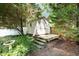 A practical shed with a small deck provides storage space at 3012 Optimist Farm Rd, Apex, NC 27539