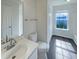 A well-lit bathroom featuring a white vanity, toilet, and walk-in shower at 308 Quartz Dr, Durham, NC 27703