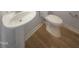 Powder room features pedestal sink, toilet, and neutral flooring at 308 Quartz Dr, Durham, NC 27703