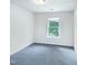 An empty bedroom featuring a window to let in natural light at 308 Quartz Dr, Durham, NC 27703
