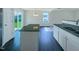 Modern kitchen featuring granite countertops, a large island, and a stainless steel sink and faucet at 308 Quartz Dr, Durham, NC 27703