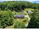 High-angle shot shows the house and guest house and the land around it on a beautiful sunny day at 311 Rassie Crabtree Rd, Rougemont, NC 27572