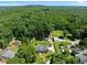 Expansive aerial view of the home and its lush surroundings, including mature trees at 311 Rassie Crabtree Rd, Rougemont, NC 27572