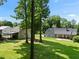 View of back of home showing large patio and guest house at 311 Rassie Crabtree Rd, Rougemont, NC 27572