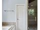Bathroom featuring white door, granite countertop, and glass shower with tile wall at 311 Rassie Crabtree Rd, Rougemont, NC 27572