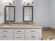 Elegant bathroom with double sinks, granite countertop, and contemporary lighting fixtures at 311 Rassie Crabtree Rd, Rougemont, NC 27572