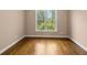 Bright bedroom with hardwood floors and a window offering natural light and a view at 311 Rassie Crabtree Rd, Rougemont, NC 27572