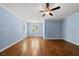 Light-filled bedroom with beautiful hardwood floors and serene blue walls at 311 Rassie Crabtree Rd, Rougemont, NC 27572