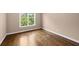 The bedroom has a window for natural light and beautiful hardwood flooring at 311 Rassie Crabtree Rd, Rougemont, NC 27572