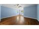 Bright bedroom showcasing hardwood floors, light blue walls and natural light from many windows at 311 Rassie Crabtree Rd, Rougemont, NC 27572