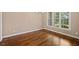 Bright bedroom with hardwood floors and a window overlooking the backyard at 311 Rassie Crabtree Rd, Rougemont, NC 27572