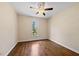This bedroom features a ceiling fan, hardwood floors, and a window at 311 Rassie Crabtree Rd, Rougemont, NC 27572